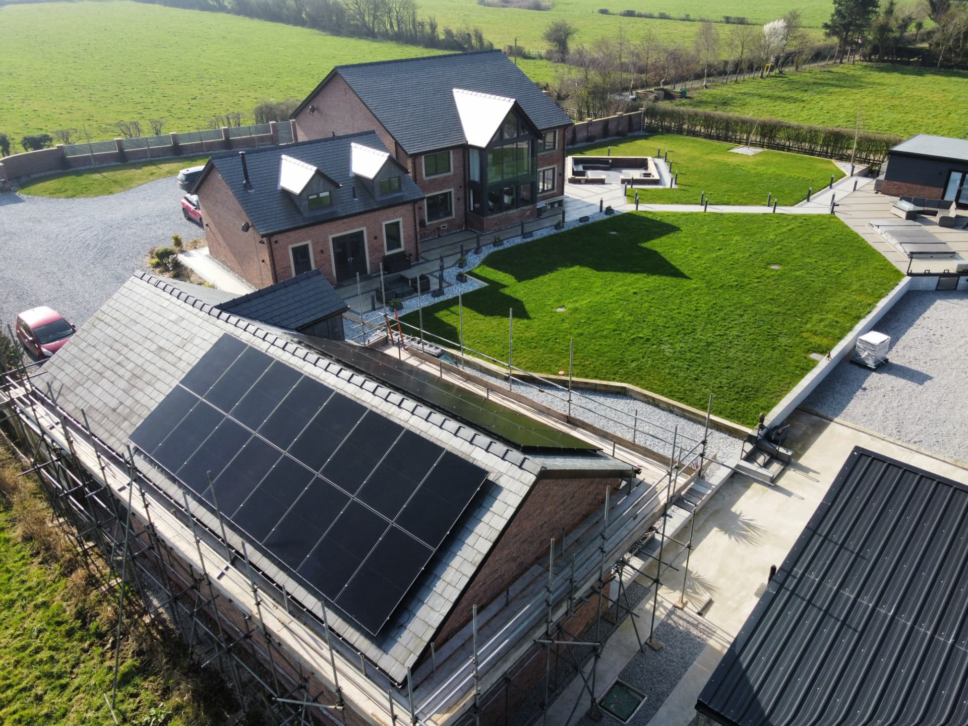 Drone view of 30 solar panels on a large slate-roofed barn conversion in Elswick, Lancashire